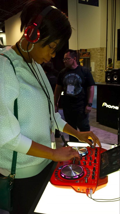 Belinda Pickens of San Diego, enjoy testing out Pioneer head set and Dj mixer equipment.