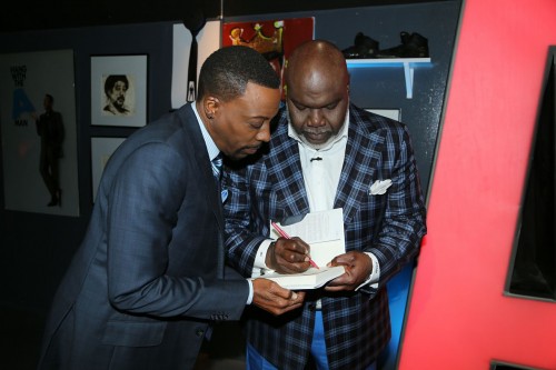 Bishop Jakes, signs a personalized copy for talk show host Arsenio Hall.  Photo courtesy of the Arsenio Hall Show. 