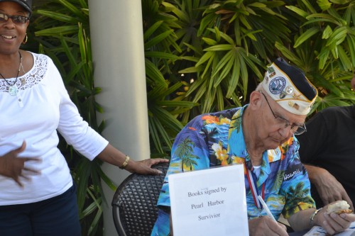 Pearl Harbor Survivor signs autographs.