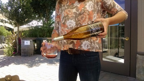 Friendly Hostess pours  a glass of the Pinot Noir.