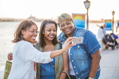 Mitchell family members enjoy taking selfies at reunion.